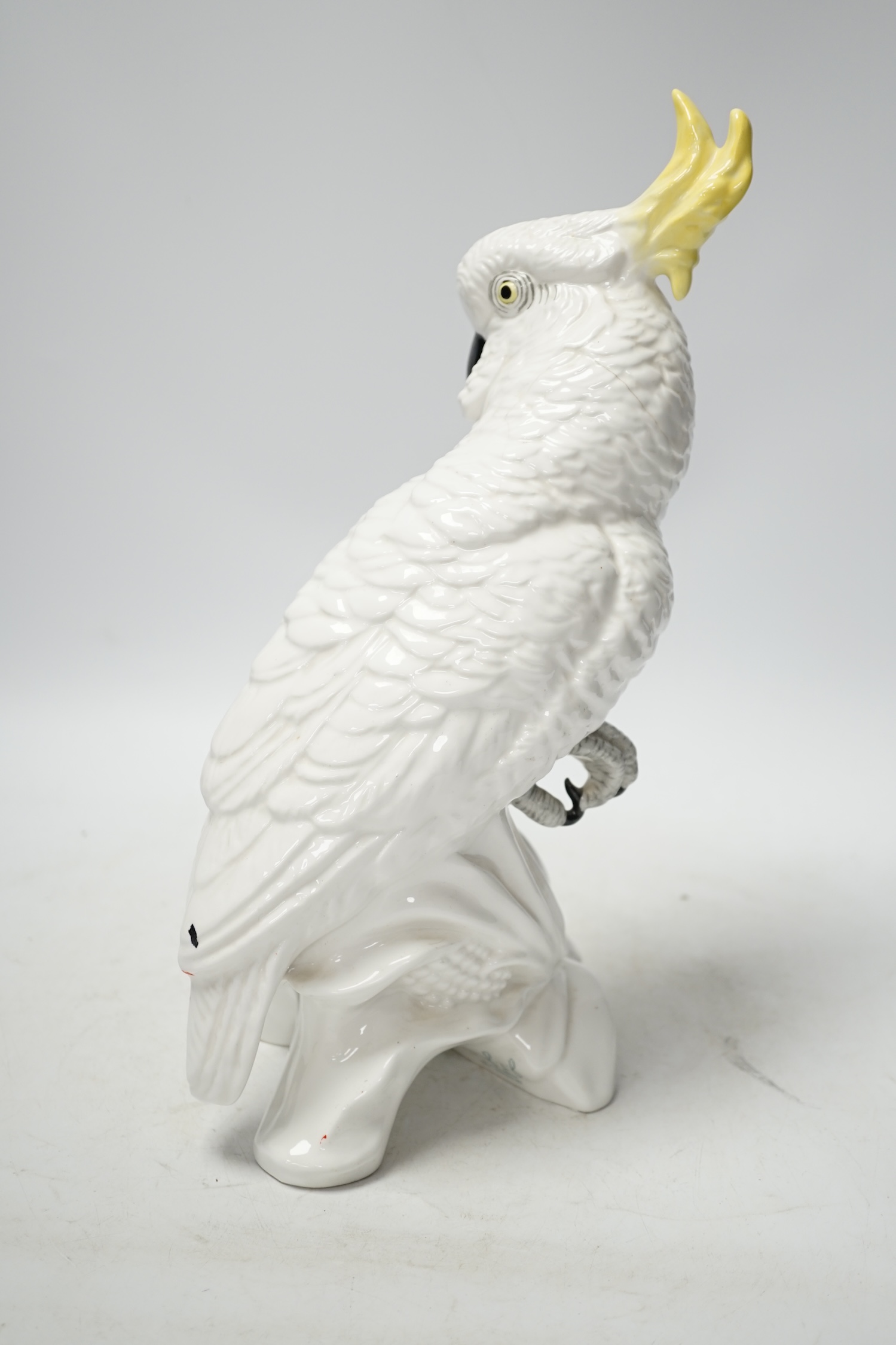 A Doulton and Slater’s patent stoneware vase and a Royal Staffordshire porcelain figure of a cockatoo, 33cm high. Condition - poor to fair condition, significant cracks to cockatoo